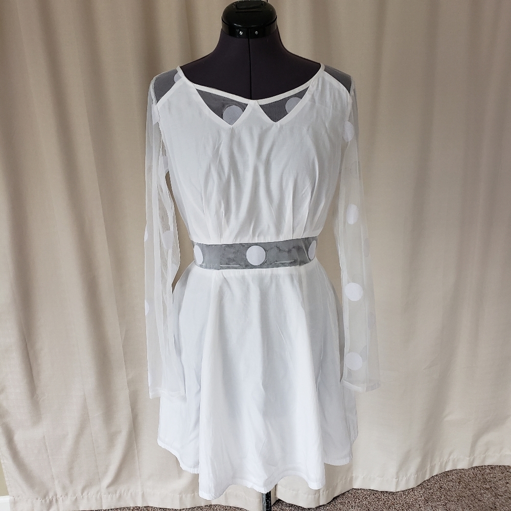 White dress with sheer cutouts and polka dots